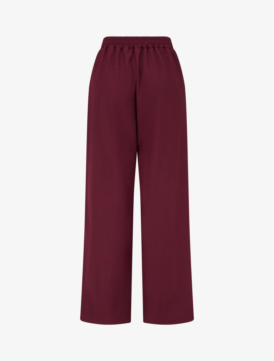 Pantalón ancho de talle alto con adorno de fantasía. - Color vino